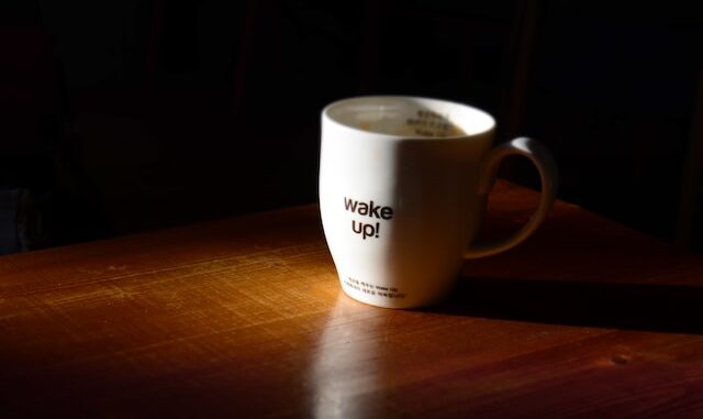 Photo of coffee cup with "wake-up" written on side.
