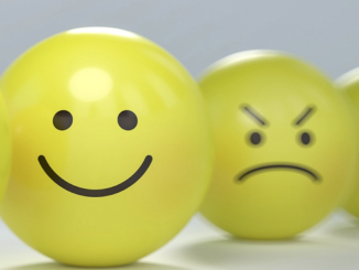 Smiley face and mad face on yellow spheres.