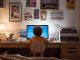 Child at a desk looking at a computer screen